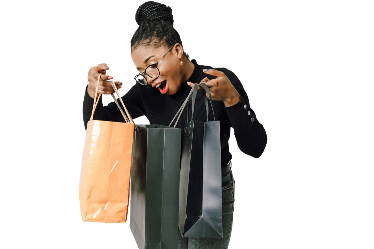 A woman looking excitedly into her shopping bags